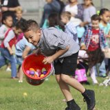 The Lemoore Lions and South Valley Church scattered about 30,000 eggs in Lemoore, much to the delight of this young man.